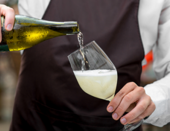 image of chef pouring glass of wine